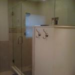 LARGE WALK IN SHOWER WITH HALF WALL, BENCH, RECESS BOX, AND GLASS SHOWER DOOR