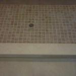 SHOWER FLOOR WITH NEW LINER,MUD BASE , MOSAIC TILE, MARBLE CURB AND GROUT.