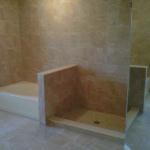 KNEE WALL SEPERATING READY FOR GLASS ENCLOSURE. SHOWER FLOOR ITALIAN MOSAIC GRIDS WITH SQUARE DRAIN.